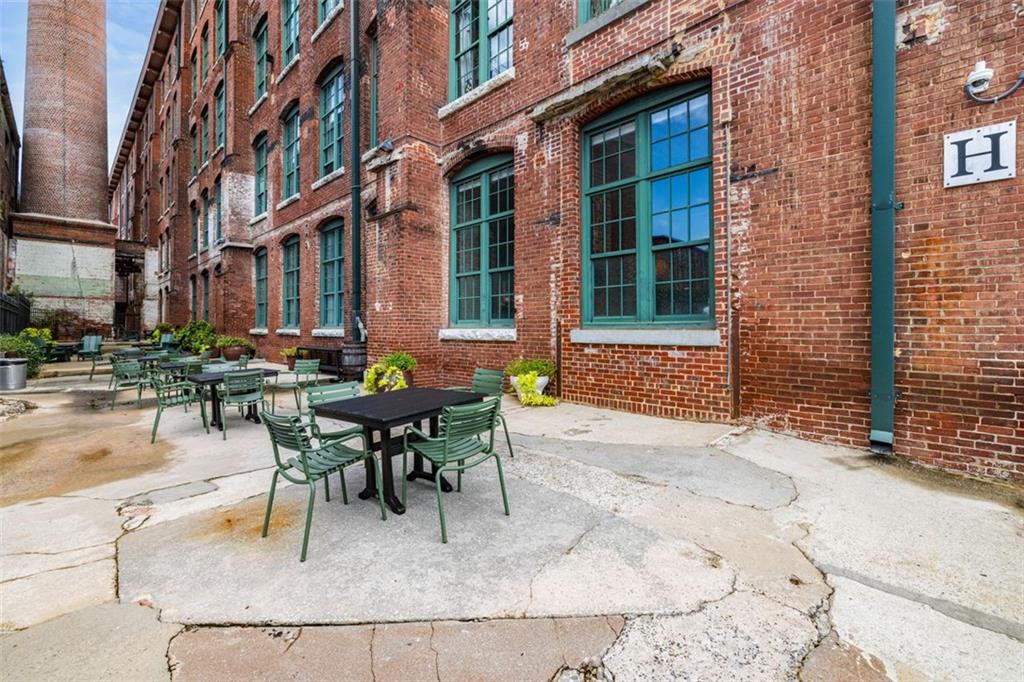 170 Boulevard Southeast, Unit 211H Atlanta, GA 30312 - Photo 35 of 49 a view of a dinning tables and chairs in a patio