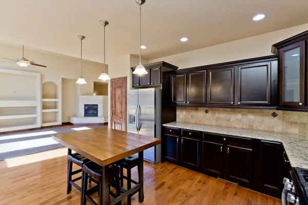 a kitchen with a table chairs refrigerator and microwave