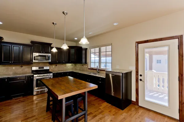 a kitchen with a stove a sink and a microwave
