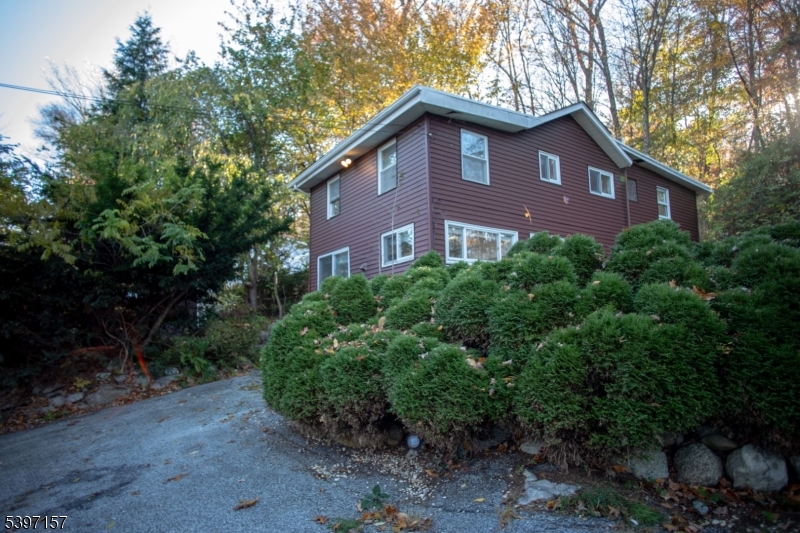 18 Decker Pond Road Vernon, NJ 07461 - Photo 11 of 40 a red brick house with trees in front of it