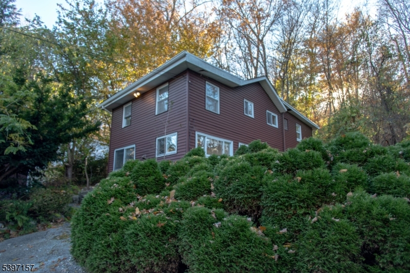 18 Decker Pond Road Vernon, NJ 07461 - Photo 12 of 40 a brick house with large windows and large trees