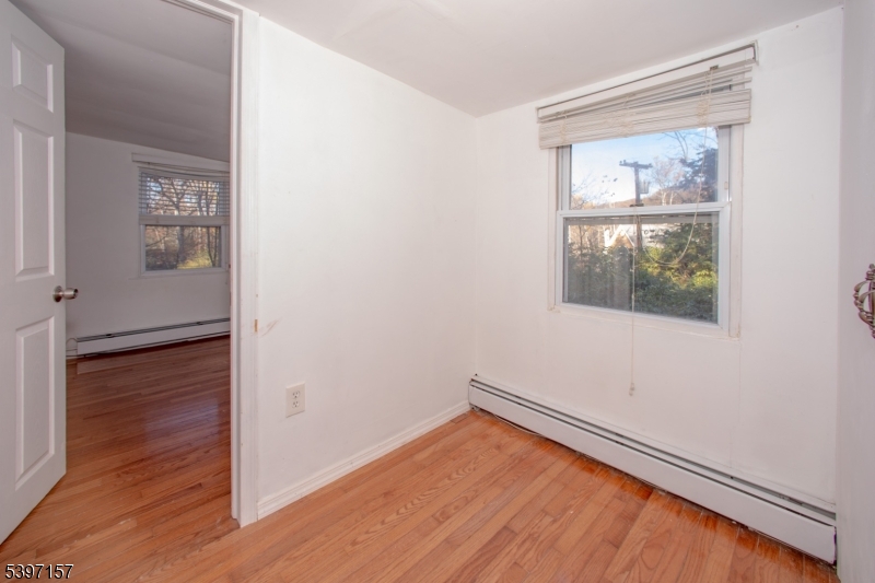 18 Decker Pond Road Vernon, NJ 07461 - Photo 14 of 40 a view of an empty room with wooden floor and a window