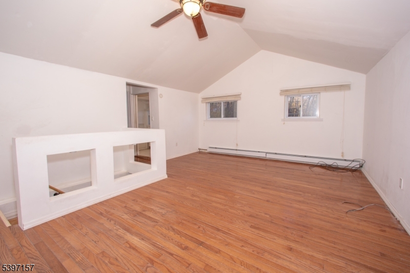 18 Decker Pond Road Vernon, NJ 07461 - Photo 18 of 40 a view of a livingroom with wooden floor and a ceiling fan