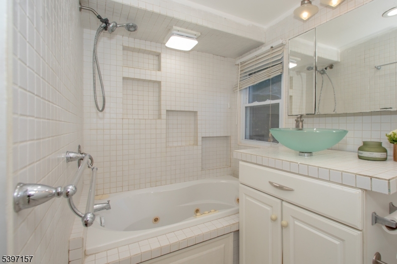 18 Decker Pond Road Vernon, NJ 07461 - Photo 20 of 40 a bathroom with a tub shower vanity and a sink
