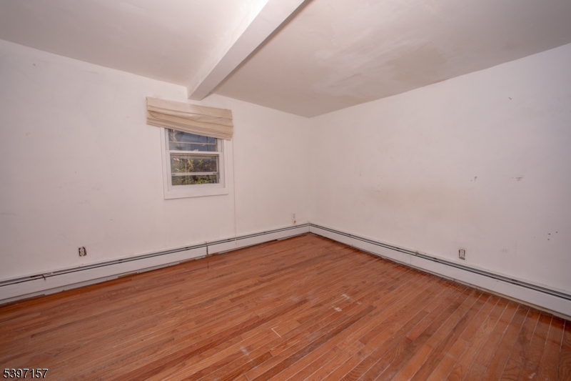 18 Decker Pond Road Vernon, NJ 07461 - Photo 21 of 40 a view of an empty room with wooden floor and a window
