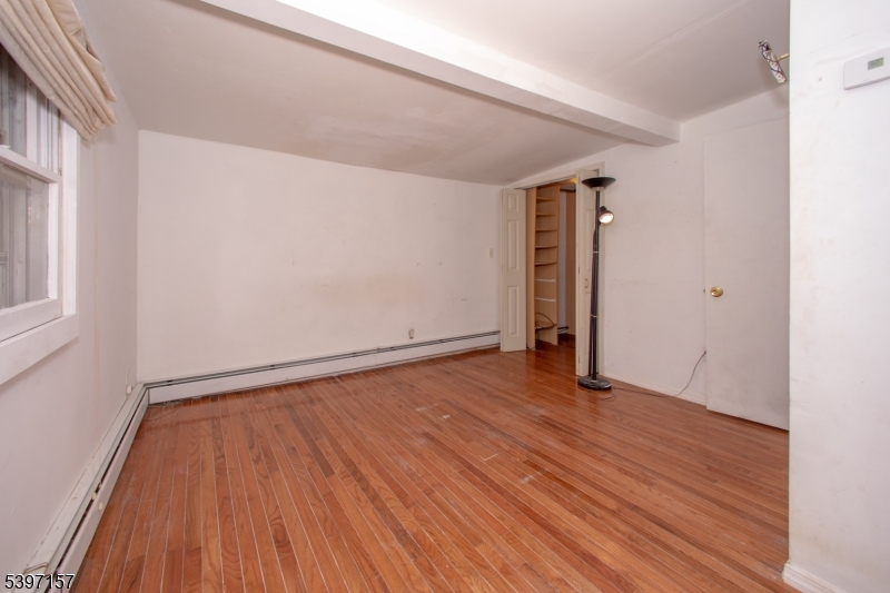 18 Decker Pond Road Vernon, NJ 07461 - Photo 22 of 40 a view of an empty room with wooden floor and a window