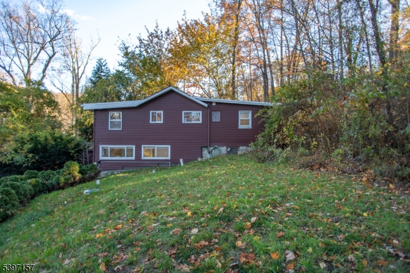 18 Decker Pond Road Vernon, NJ 07461 - Photo 9 of 40 a brick house with a big yard and large trees