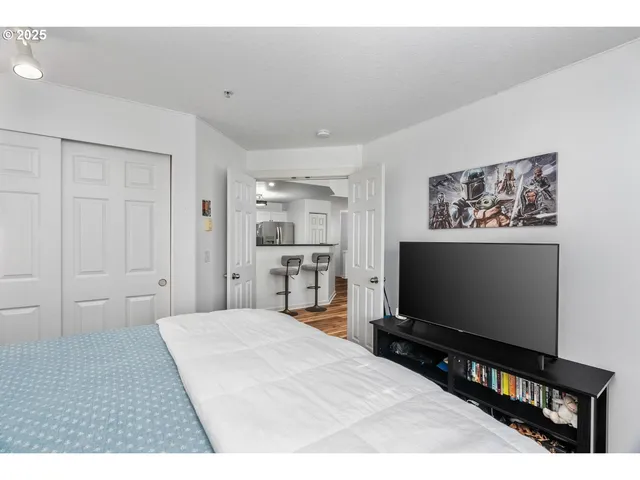 a bathroom with a granite countertop toilet sink and mirror