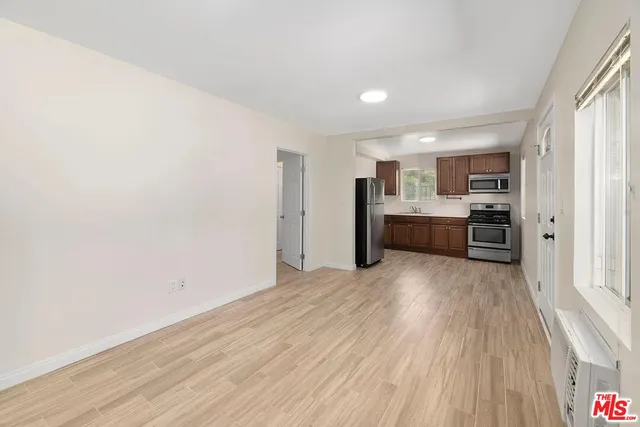 a view of a kitchen with a sink and a refrigerator