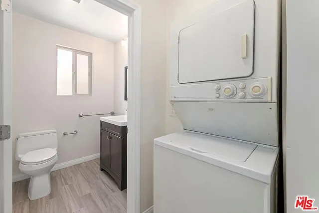 a bathroom with a toilet and a mirror