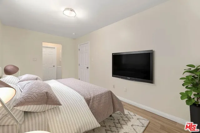 a bedroom with a bed and a flat screen tv