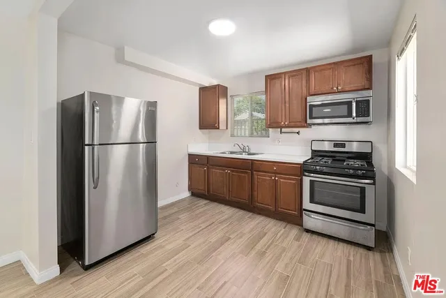 a kitchen with stainless steel appliances a refrigerator stove and microwave