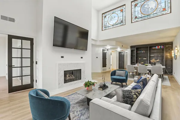a living room with furniture fireplace and flat screen tv