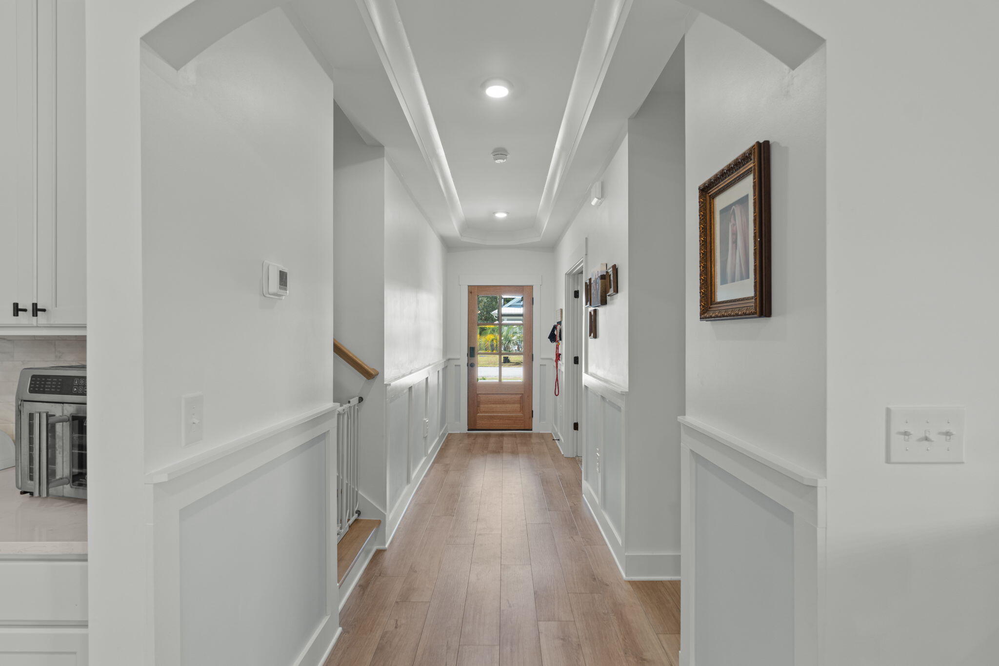 136 Hibernate Way Freeport, FL 32439 - Photo 4 of 55 a view of a hallway with wooden floor and staircase