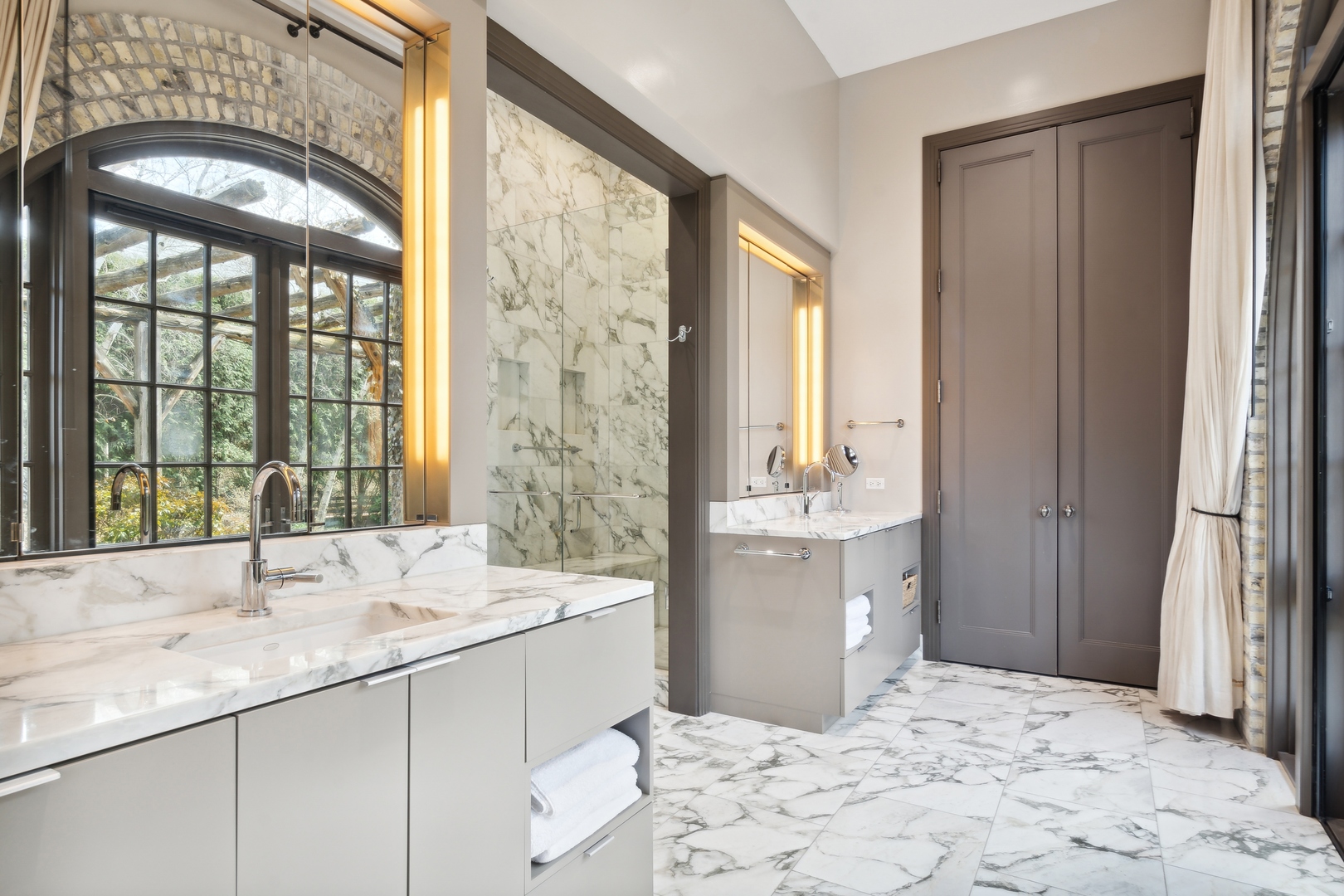 96 Ronan Road Highwood, IL 60040 - Photo 27 of 33 a bathroom with a double vanity sink bathtub and next to a window