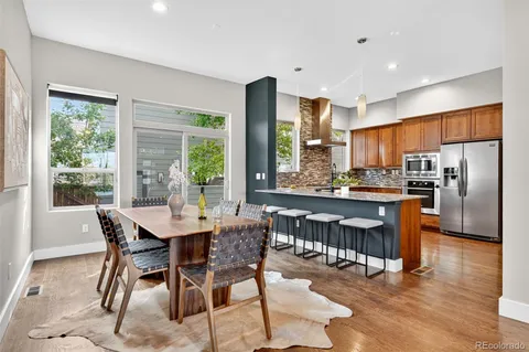 a kitchen with stainless steel appliances granite countertop a sink and a large window