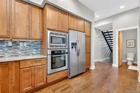 a view of a balcony with wooden floor and iron fence