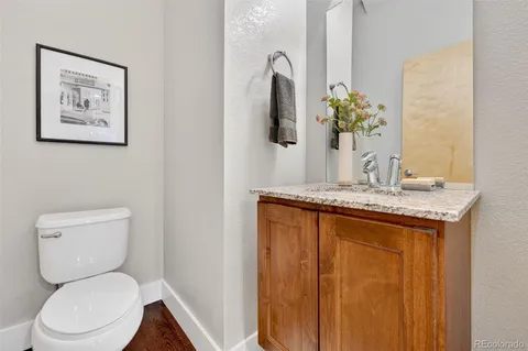 a bathroom with a granite countertop sink and a large mirror