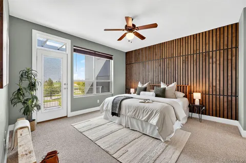 a bathroom with a granite countertop bathtub sink vanity mirror and toilet