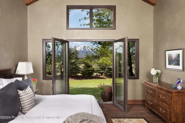 a bedroom with a bed and glass window