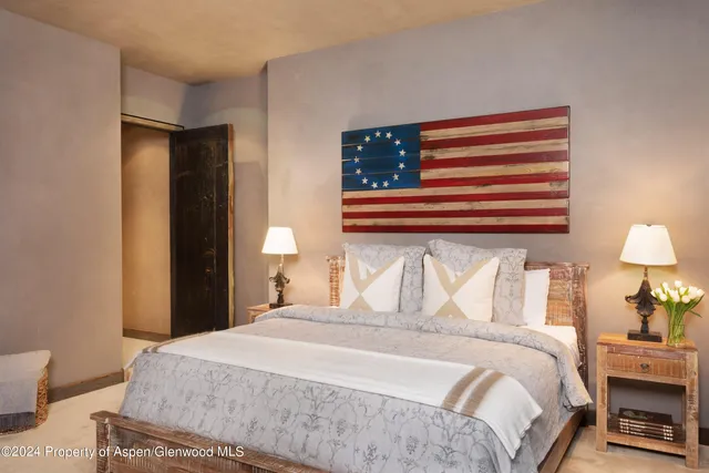 a bedroom with a bed and a lamp