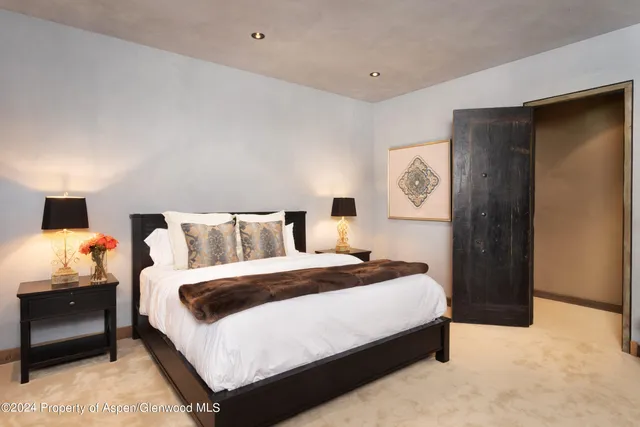 a bedroom with a bed and a lamp