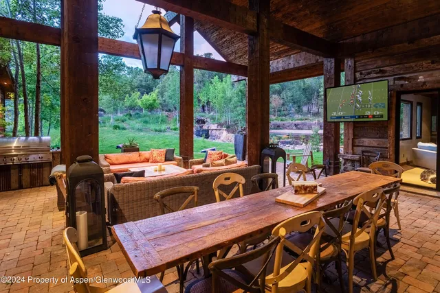 a view of a patio with a table chairs and a table