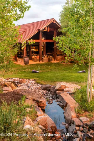 a front view of a house with a yard table and chairs