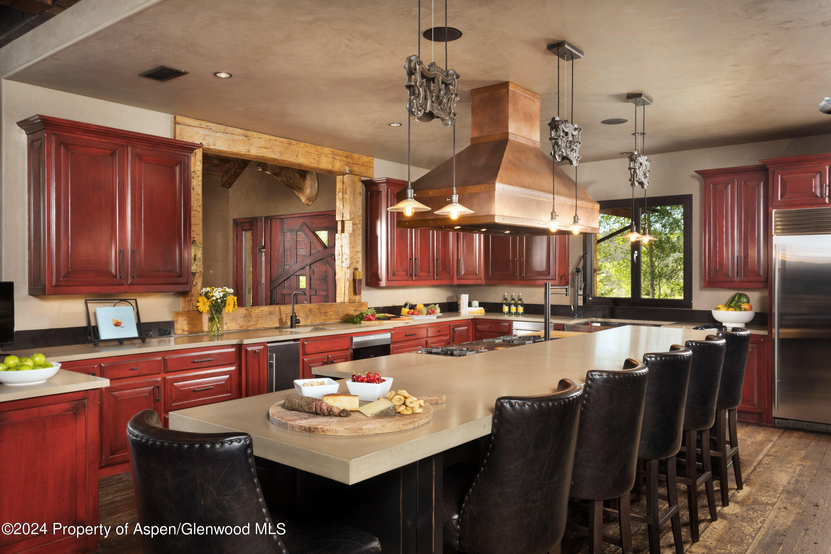 665 Callicotte Ranch Drive Carbondale, CO 81623 - Photo 8 of 39 a kitchen with a sink a counter space dining table and chairs