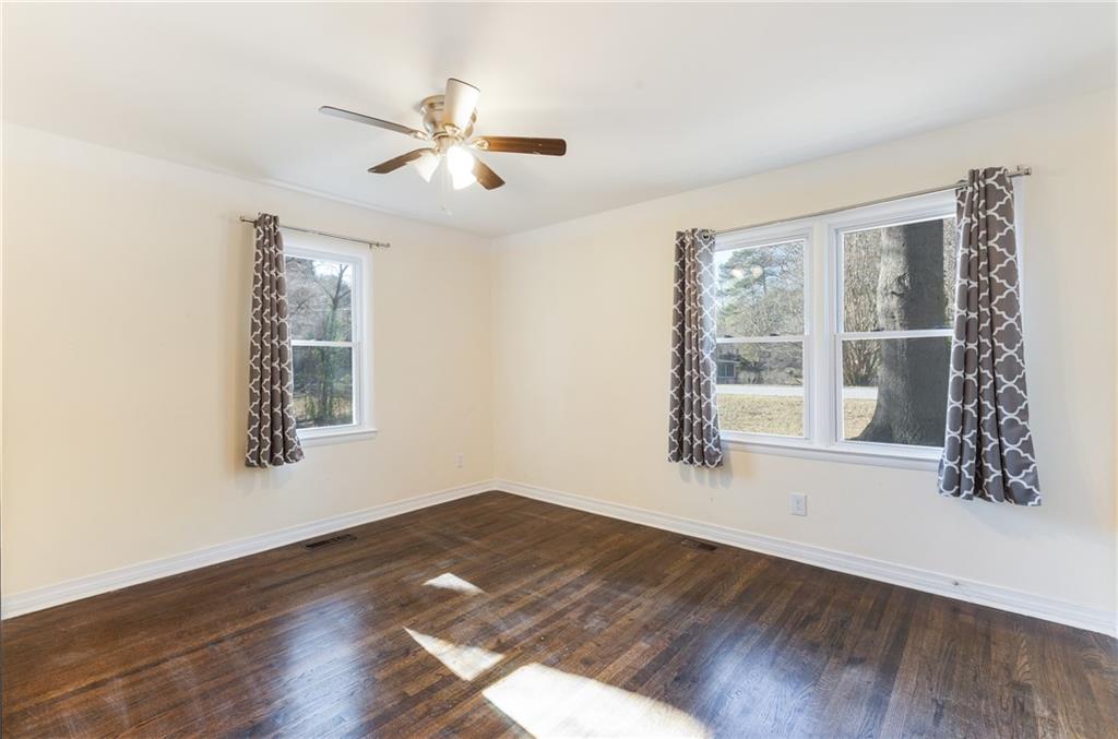 5287 Maple Valley Road Southwest Mableton, GA 30126 - Photo 11 of 29 a view of an empty room with wooden floor and a window