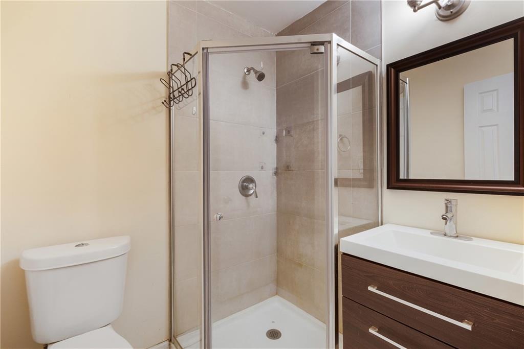 5287 Maple Valley Road Southwest Mableton, GA 30126 - Photo 18 of 29 a bathroom with a shower a sink and a mirror