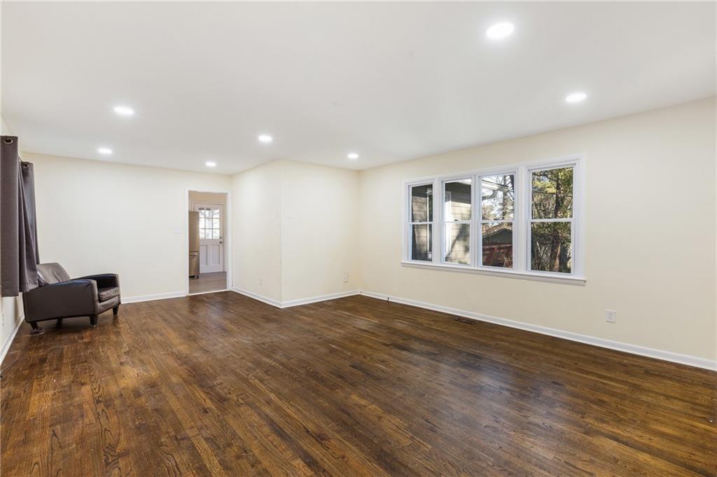 5287 Maple Valley Road Southwest Mableton, GA 30126 - Photo 2 of 29 a view of an empty room with window and wooden floor