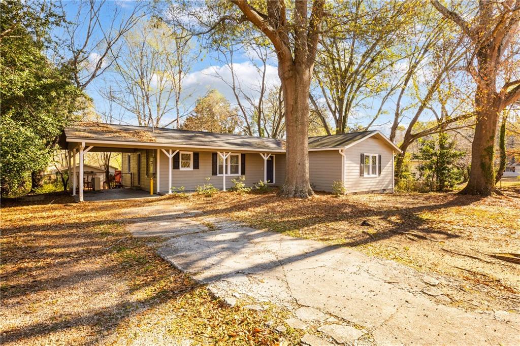 5287 Maple Valley Road Southwest Mableton, GA 30126 - Photo 26 of 29 a front view of a house with a yard and trees