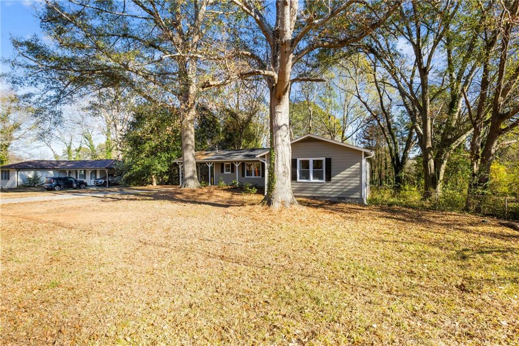 5287 Maple Valley Road Southwest Mableton, GA 30126 - Photo 27 of 29 a front view of house with yard and trees around