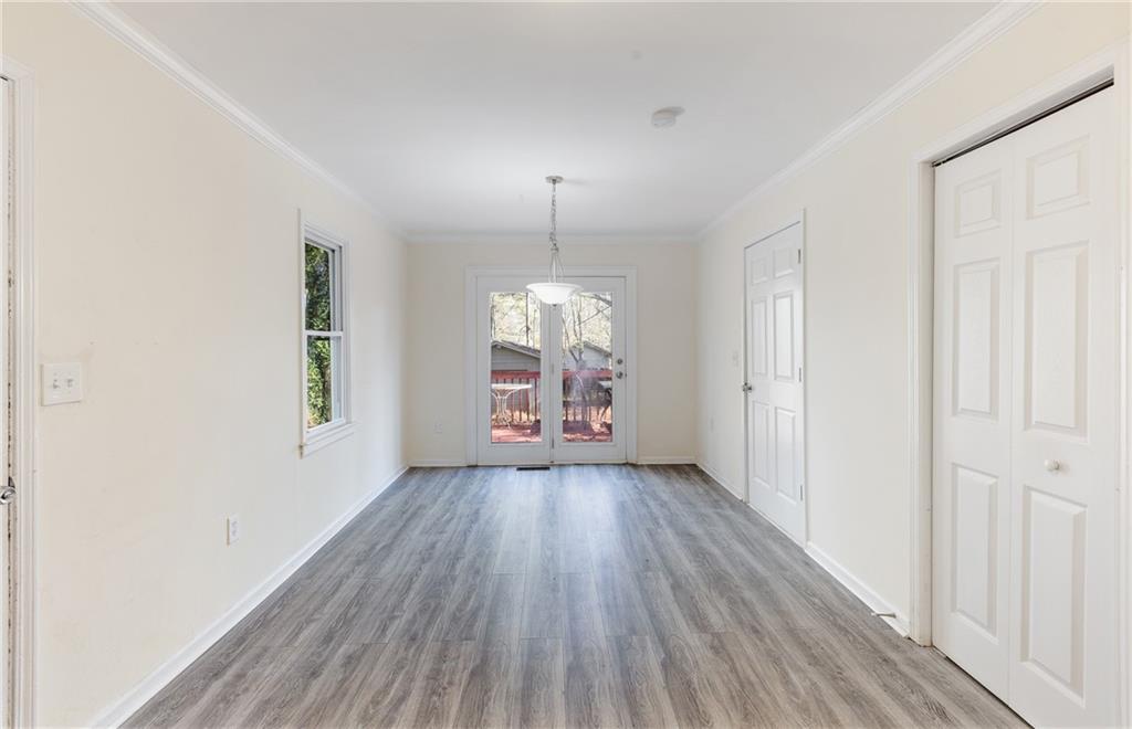5287 Maple Valley Road Southwest Mableton, GA 30126 - Photo 9 of 29 an empty room with wooden floor and windows