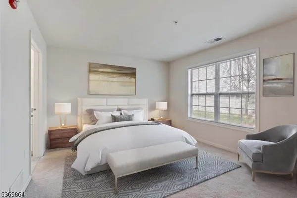 a bedroom with a bed and a couch with window