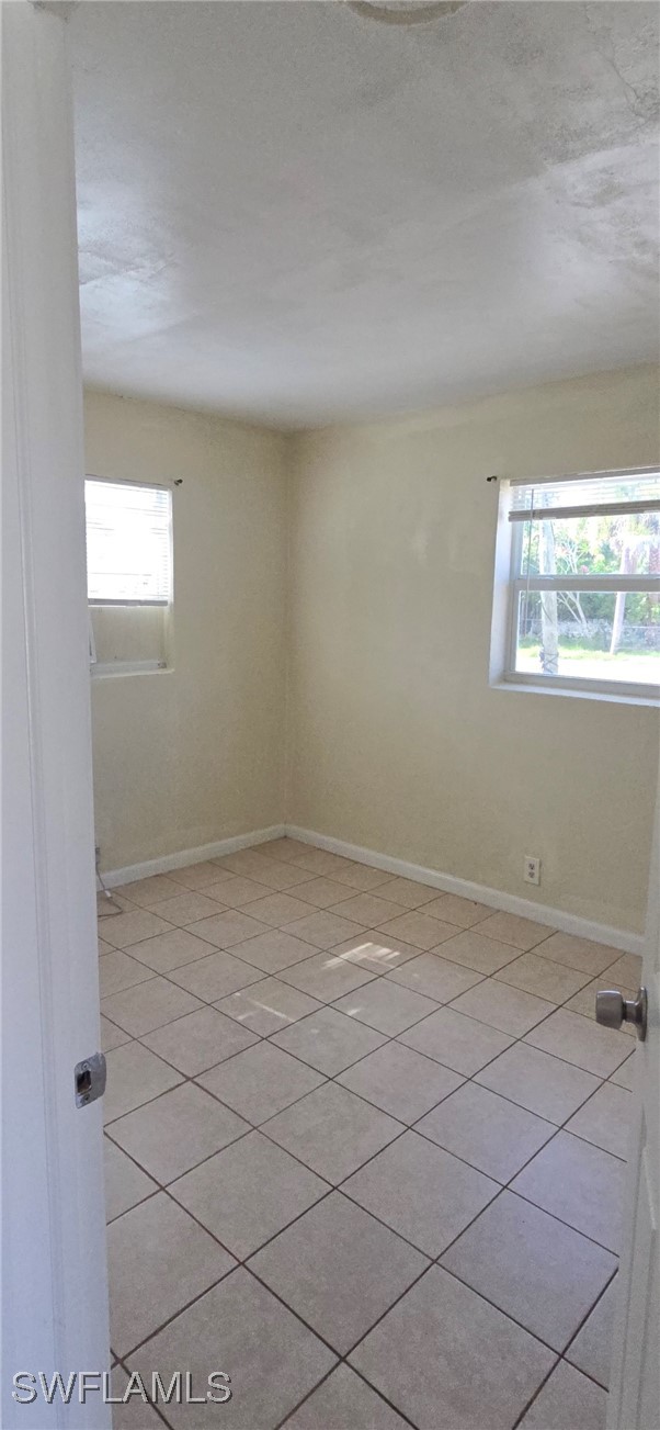 3049 2nd Street, Unit 1 Fort Myers, FL 33916 - Photo 6 of 15 an empty room with windows