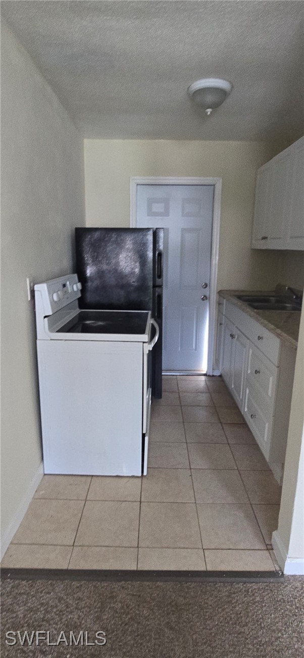 3049 2nd Street, Unit 1 Fort Myers, FL 33916 - Photo 7 of 15 a kitchen with stainless steel appliances granite countertop a sink and a stove