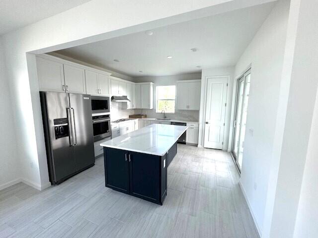 1375 Haven Circle Vero Beach, FL 32960 - Photo 18 of 36 a kitchen with stainless steel appliances a stove a refrigerator and a sink