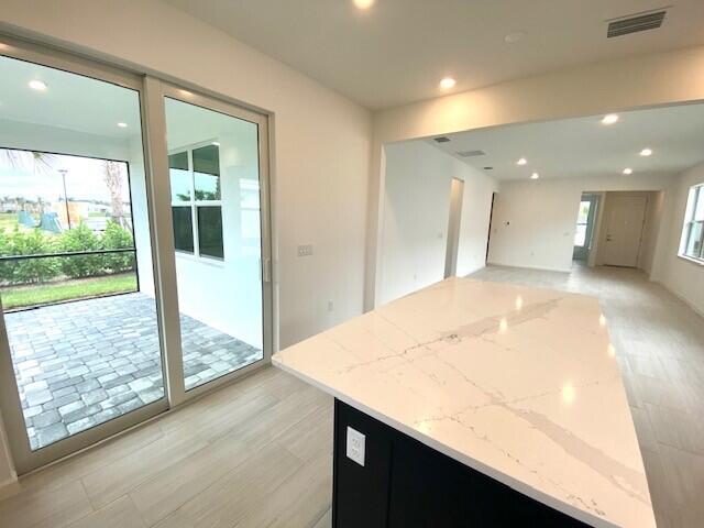 1375 Haven Circle Vero Beach, FL 32960 - Photo 19 of 36 a view of a hallway with wooden floor and a living room