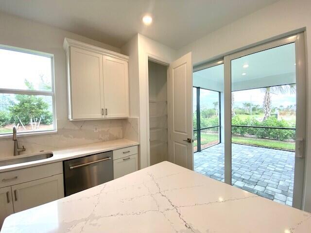 1375 Haven Circle Vero Beach, FL 32960 - Photo 20 of 36 a kitchen with a stove a sink and a large window