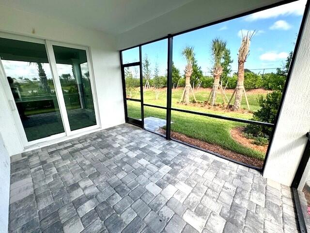 1375 Haven Circle Vero Beach, FL 32960 - Photo 28 of 36 a view of a porch with a floor to ceiling window next to a yard