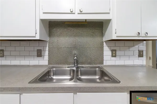 a kitchen with a sink and cabinets