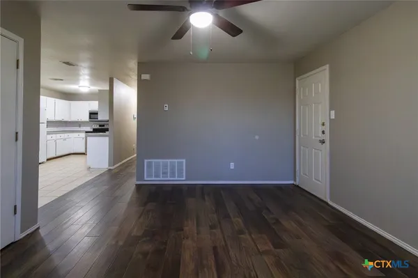 wooden floor in an empty room with a window