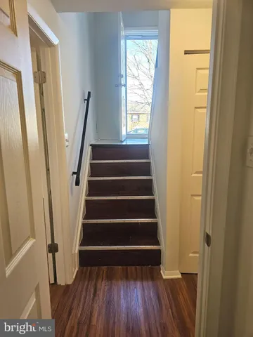 a view of entryway with wooden floor and stairs