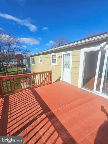 a view of a patio with wooden floor and city view