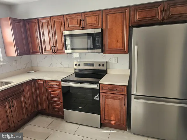 a kitchen with stainless steel appliances granite countertop a refrigerator stove a sink and dishwasher