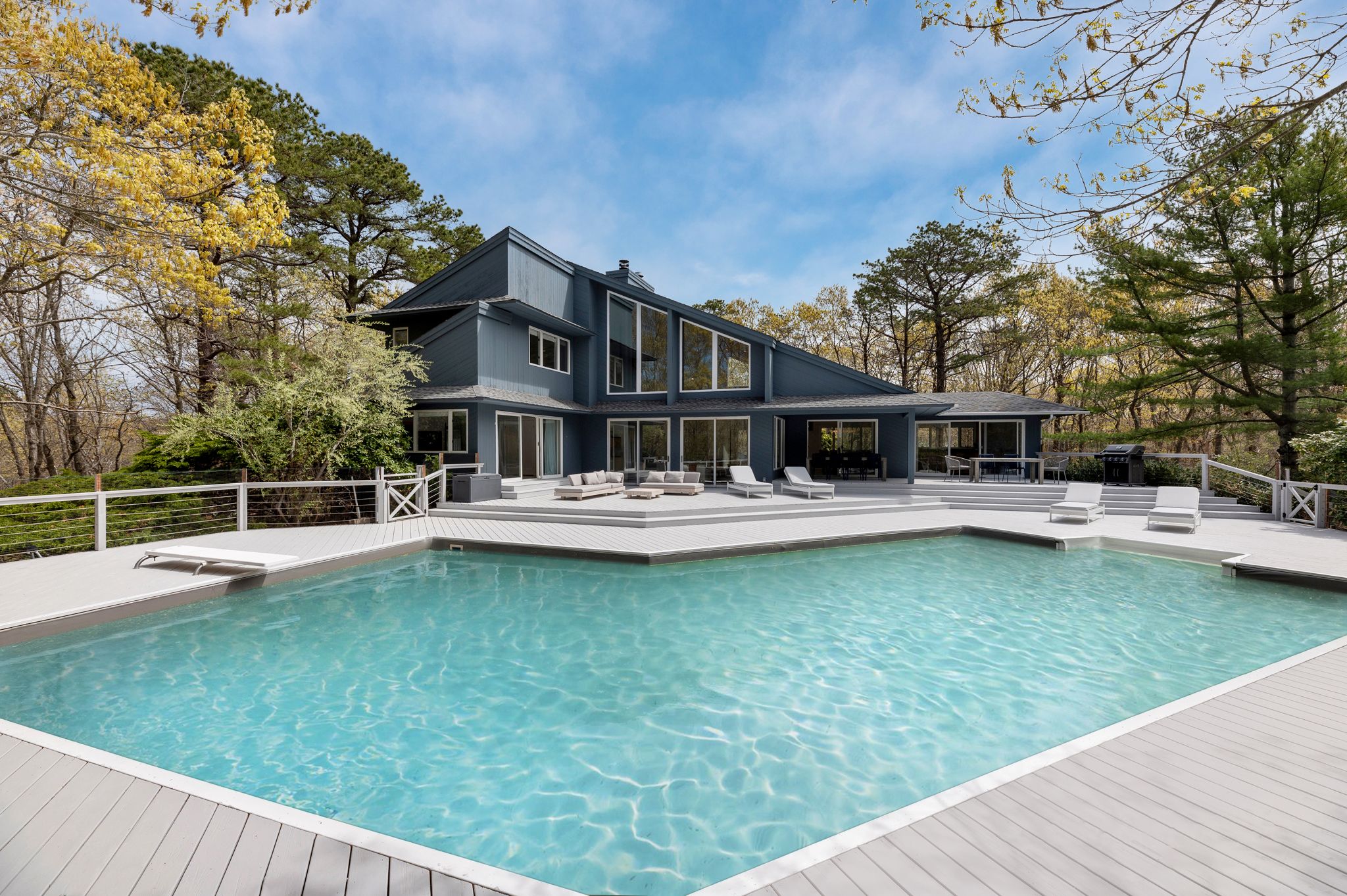 a swimming pool with outdoor seating and yard