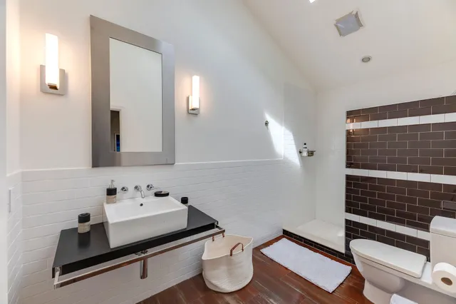 a bathroom with a sink toilet and mirror