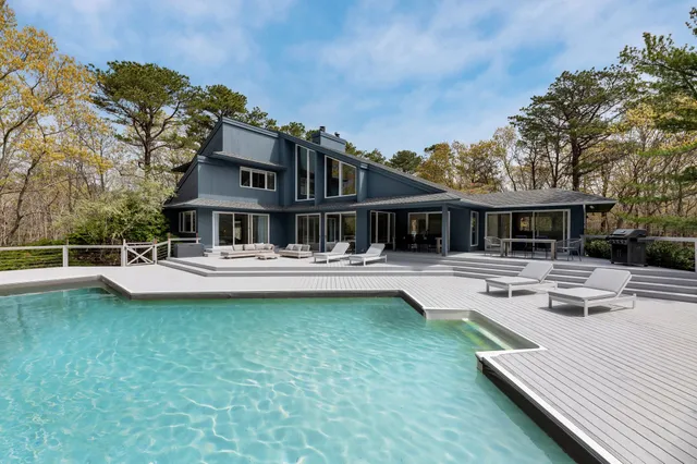 front view of a house with swimming pool and porch
